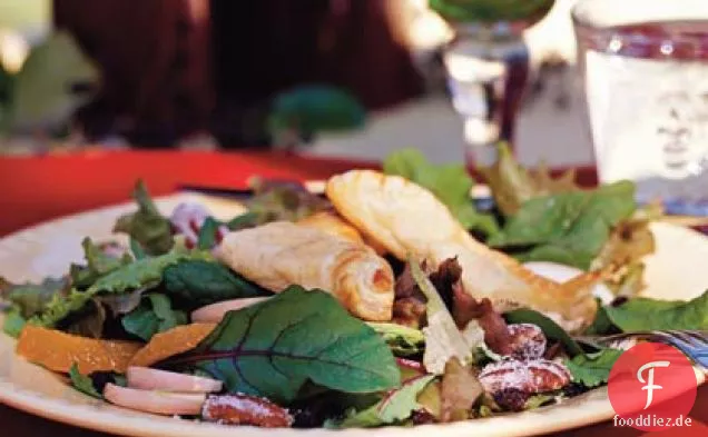 Schwarzer Pfeffer-Chèvre-Gebäck auf gemischtem Wintergrün mit Cranberry-Port-Vinaigrette und kandierten Pekannüssen