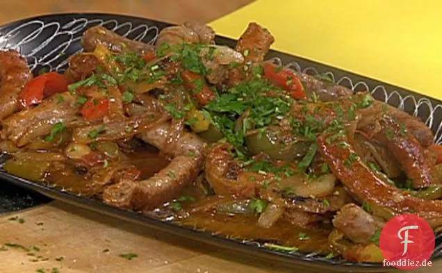 Gebratene Würste, Paprika und Zwiebeln und Käsebrot mit schwarzem Pfeffer