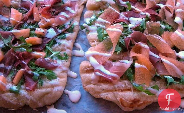 Gegrillte Pizza mit Schinken, Melone, Rucola und Creme Fraiche